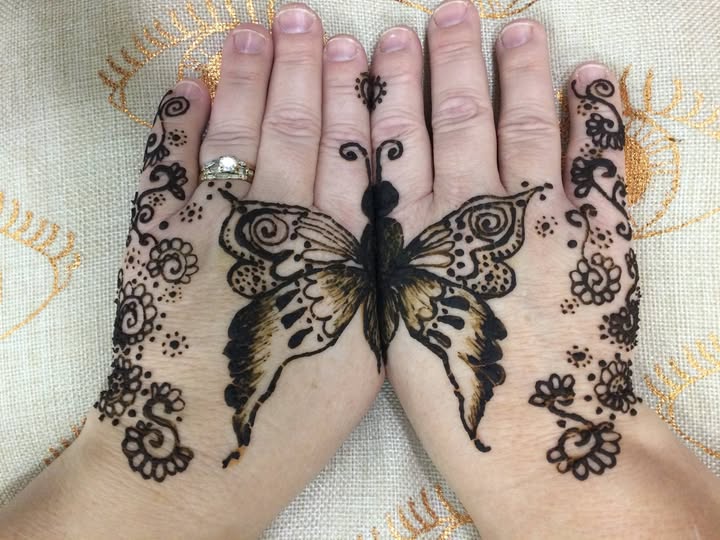 Henna two hands together forming a butterfly